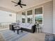 Covered patio with wicker furniture, a striped rug, and a view of the backyard, perfect for outdoor living at 924 Stebbins Dr, Fort Mill, SC 29715