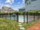 Backyard swimming pool with a safety fence, surrounded by green grass and landscaping, great for Gathering fun at 924 Stebbins Dr, Fort Mill, SC 29715