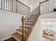 Traditional staircase featuring wood treads, white risers, dark metal railings, and wood banister at 924 Stebbins Dr, Fort Mill, SC 29715