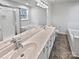 Bright bathroom features double sinks, a soaking tub, and a separate shower at 10301 Shelter Rock Ct, Charlotte, NC 28214