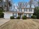 Charming two-story home featuring a garage, blue shutters, and well-manicured landscaping at 10301 Shelter Rock Ct, Charlotte, NC 28214