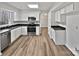 Modern kitchen features stainless steel appliances, updated flooring, and ample cabinet space at 10301 Shelter Rock Ct, Charlotte, NC 28214