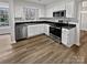 Updated kitchen features stainless steel appliances, stone countertops, and bright white cabinetry at 10301 Shelter Rock Ct, Charlotte, NC 28214