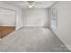 Bright, open living room with neutral walls, plush carpeting, and lots of natural light at 10301 Shelter Rock Ct, Charlotte, NC 28214