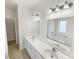 Bright bathroom featuring double sink vanity, large mirrors, and soaking tub at 104 Tarrington Dr, Statesville, NC 28625