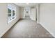 Spacious carpeted bedroom featuring bright natural light from large windows at 104 Tarrington Dr, Statesville, NC 28625