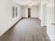 Neutral carpeted bedroom with an open doorway and a ceiling fan providing light at 104 Tarrington Dr, Statesville, NC 28625