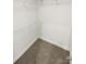 Empty walk-in closet featuring white wire shelving and neutral carpet, providing ample storage space at 104 Tarrington Dr, Statesville, NC 28625