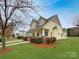 Charming two-story home with inviting porch, landscaped yard, and classic architectural details at 104 Tarrington Dr, Statesville, NC 28625