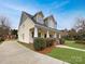 Charming two-story home with inviting porch, landscaped yard, and classic architectural details at 104 Tarrington Dr, Statesville, NC 28625