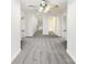 Bright hallway featuring neutral gray carpet, a modern ceiling fan, and crisp white walls at 104 Tarrington Dr, Statesville, NC 28625