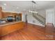 Spacious open-concept kitchen with stainless steel appliances, granite countertops, and hardwood floors at 104 Tarrington Dr, Statesville, NC 28625