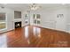 Bright living room featuring hardwood floors, a cozy fireplace, and large windows at 104 Tarrington Dr, Statesville, NC 28625