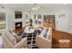 Bright living room featuring hardwood floors, a cozy fireplace, modern furniture, and large windows at 104 Tarrington Dr, Statesville, NC 28625