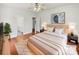 Cozy bedroom with wood floors, a large bed, neutral color scheme and an ensuite bathroom at 104 Tarrington Dr, Statesville, NC 28625