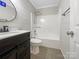 Updated bathroom features modern fixtures, tile floors, and a shower-tub combo at 106 Cape Breton Trl, Gastonia, NC 28056
