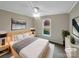 Cozy bedroom featuring a ceiling fan, neutral color palette, and large window with natural light at 106 Cape Breton Trl, Gastonia, NC 28056