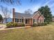 Charming brick home with black shutters and well-maintained landscaping in a tranquil neighborhood at 106 Cape Breton Trl, Gastonia, NC 28056