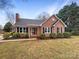 Charming brick home with black shutters and well-maintained landscaping in a tranquil neighborhood at 106 Cape Breton Trl, Gastonia, NC 28056