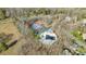 Aerial view of community tennis courts, community pool, and clubhouse nestled among mature trees at 10615 Persimmon Creek Dr, Mint Hill, NC 28227