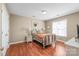 Bedroom with hardwood floors featuring a bed with a quilt and a wicker dresser at 10615 Persimmon Creek Dr, Mint Hill, NC 28227