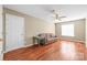 Bedroom with wood floors, a ceiling fan, and a leather couch at 10615 Persimmon Creek Dr, Mint Hill, NC 28227