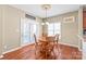 Charming breakfast nook features wood table and chairs, natural light from patio doors and window at 10615 Persimmon Creek Dr, Mint Hill, NC 28227
