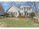 Charming two-story home featuring a well-maintained lawn and complemented by mature trees and manicured shrubbery at 10615 Persimmon Creek Dr, Mint Hill, NC 28227