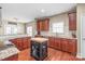 Spacious kitchen features wooden cabinets, granite countertops, island, and stainless steel appliances at 10615 Persimmon Creek Dr, Mint Hill, NC 28227