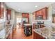 Well-equipped kitchen with granite countertops, wood cabinets, stainless steel appliances, and a central island at 10615 Persimmon Creek Dr, Mint Hill, NC 28227