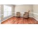 Cozy living room features hardwood floors, large window, and two upholstered armchairs at 10615 Persimmon Creek Dr, Mint Hill, NC 28227