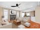 Inviting living room with fireplace, hardwood floors, ceiling fan, and comfortable seating at 10615 Persimmon Creek Dr, Mint Hill, NC 28227