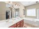 Spacious bathroom with dual sinks, ample counter space, a soaking tub, and a separate glass shower at 10615 Persimmon Creek Dr, Mint Hill, NC 28227