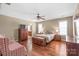 Comfortable bedroom featuring hardwood floors, classic furniture, and an adjoining bathroom at 10615 Persimmon Creek Dr, Mint Hill, NC 28227