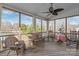 Screened-in porch offering multiple seating options and a ceiling fan for comfort at 10615 Persimmon Creek Dr, Mint Hill, NC 28227