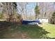 Backyard featuring a pool covered with a blue tarp, a small shed, and a deck at 107 Stanford Dr, Stanley, NC 28164