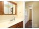 Bathroom vanity with wood cabinets, chrome faucet, and a medicine cabinet mirror at 107 Stanford Dr, Stanley, NC 28164
