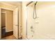Bathroom featuring a shower-tub combo with white tile surround and chrome fixtures at 107 Stanford Dr, Stanley, NC 28164