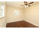 Bright bedroom featuring hardwood floors, a ceiling fan, and a window offering natural light at 107 Stanford Dr, Stanley, NC 28164