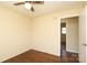 Bedroom featuring hardwood floors, ceiling fan, and an open closet door at 107 Stanford Dr, Stanley, NC 28164