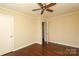 Bedroom with hardwood floors, ceiling fan, a window, and a closet door at 107 Stanford Dr, Stanley, NC 28164