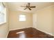 Bedroom with hardwood floors, a ceiling fan, and a window offering natural light at 107 Stanford Dr, Stanley, NC 28164