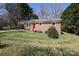 Quaint one-story brick home with a bright red front door and well-kept lawn at 107 Stanford Dr, Stanley, NC 28164