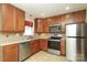 Well-equipped kitchen featuring stainless steel appliances, wooden cabinets, and modern fixtures at 107 Stanford Dr, Stanley, NC 28164