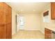 Eat-in kitchen with hardwood floors, ample storage, and a door leading to the outside at 107 Stanford Dr, Stanley, NC 28164