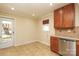 Cozy kitchen featuring tiled floors, wood cabinetry and stainless steel dishwasher at 107 Stanford Dr, Stanley, NC 28164