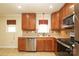 Modern kitchen with stainless steel appliances, wood cabinets, and tile backsplash at 107 Stanford Dr, Stanley, NC 28164