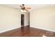 Open living room with hardwood floors, ceiling fan, and views into the kitchen at 107 Stanford Dr, Stanley, NC 28164