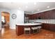 Modern kitchen featuring wooden cabinets, stainless steel appliances, and a large island with bar seating at 10911 Round Rock Rd, Charlotte, NC 28277