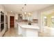 Modern kitchen featuring white cabinets, quartz countertops, stainless steel appliances, and tile backsplash at 10914 Ridge Acres Rd, Charlotte, NC 28214